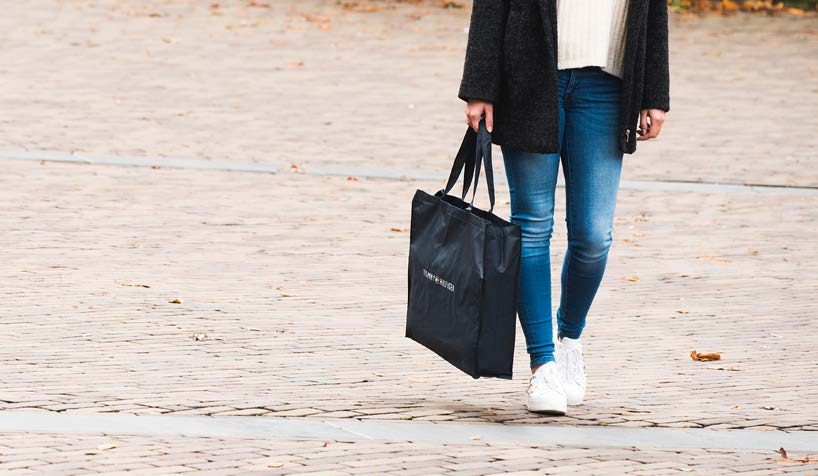 Woman carrying a black carrying bag